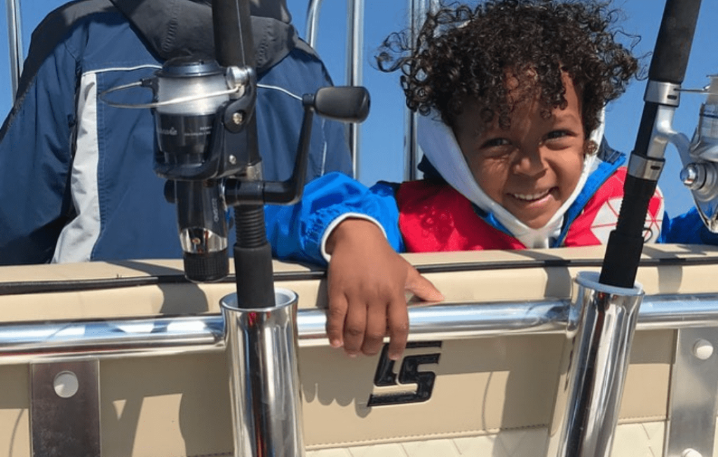 Little boy smiling on boat. 