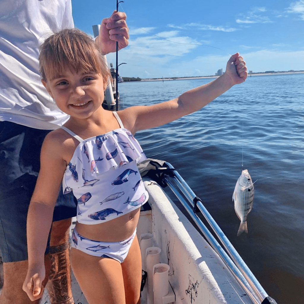 Marty's daughter holding a fish
